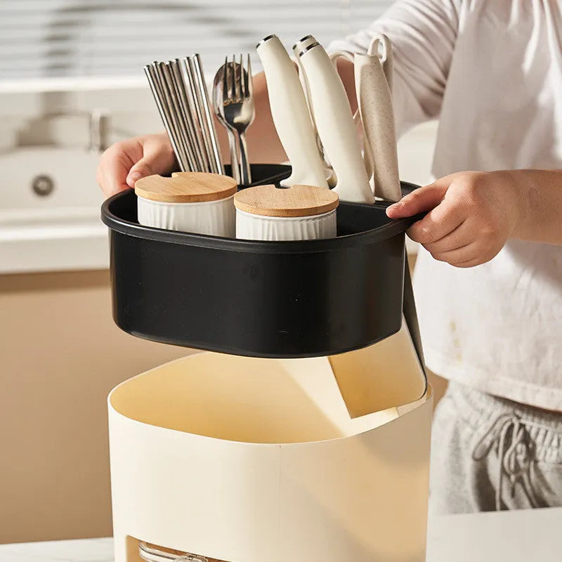 Rotating kitchen storage organiser with spice box compartments on countertop