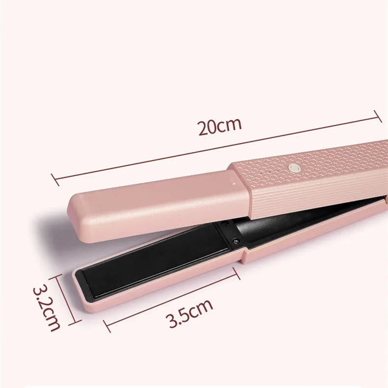 Pink and green mini cordless USB hair straightener with ceramic plates open on a white background.