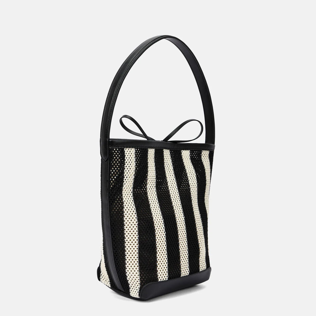 Black and white striped woven shoulder bag with bucket shape showing dimensions