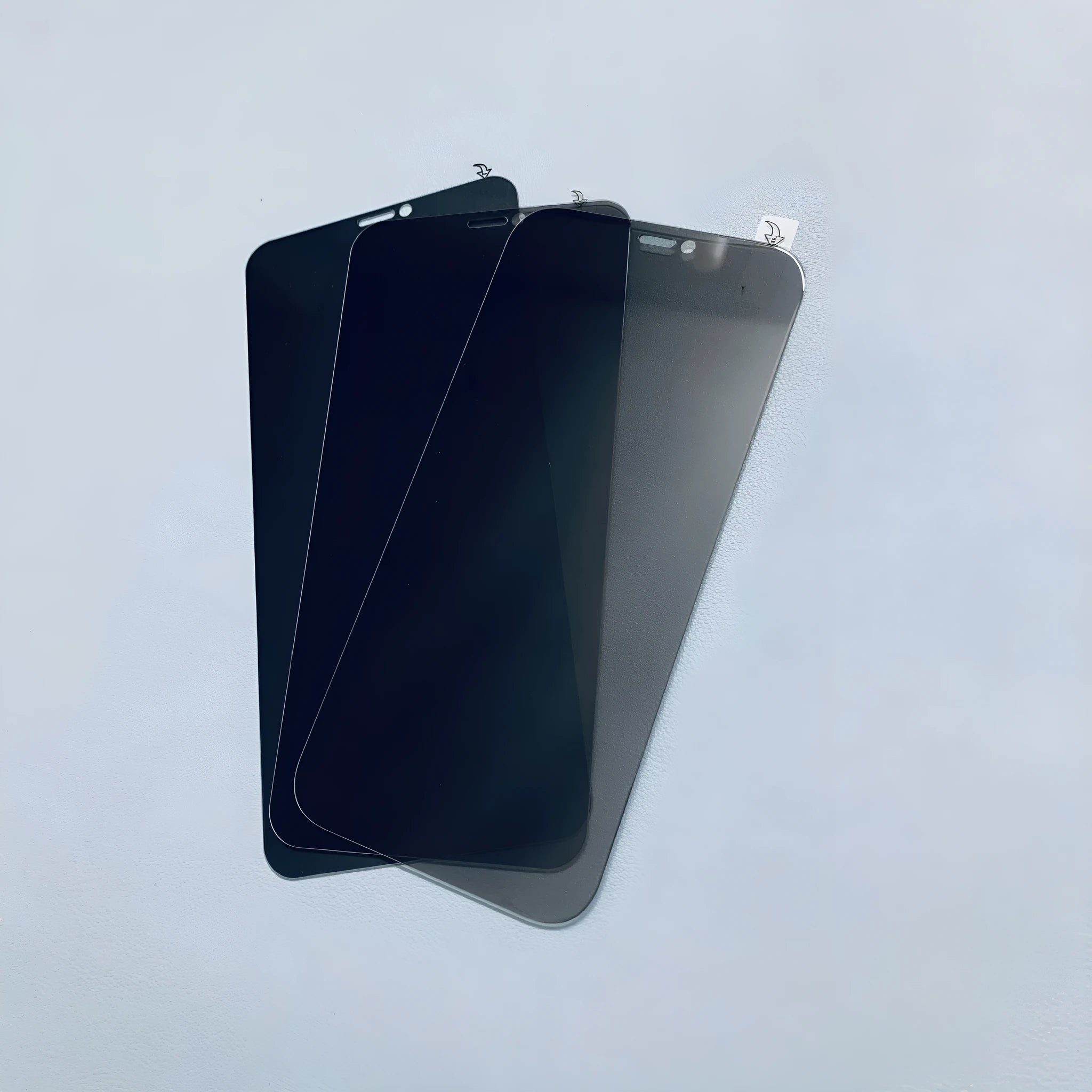 iPhone anti-peeping tempered glass screen protector showing privacy filter effect from side angle.