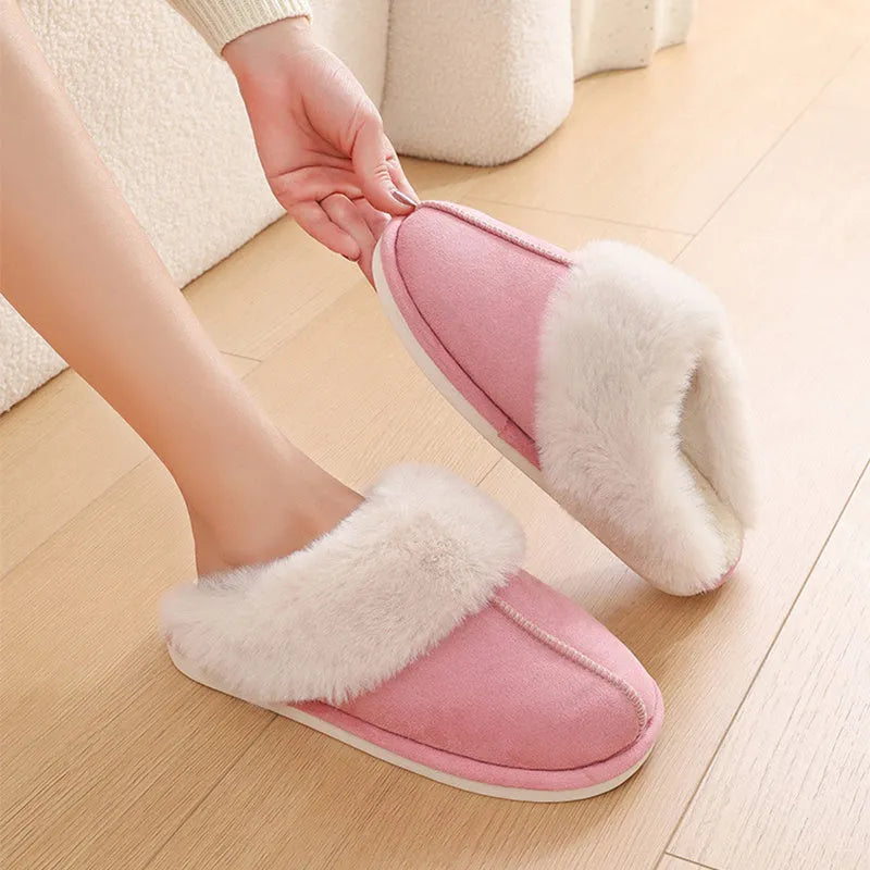 Brown plush indoor slippers with round toe, flat heel, and stitched detail on a PVC sole.