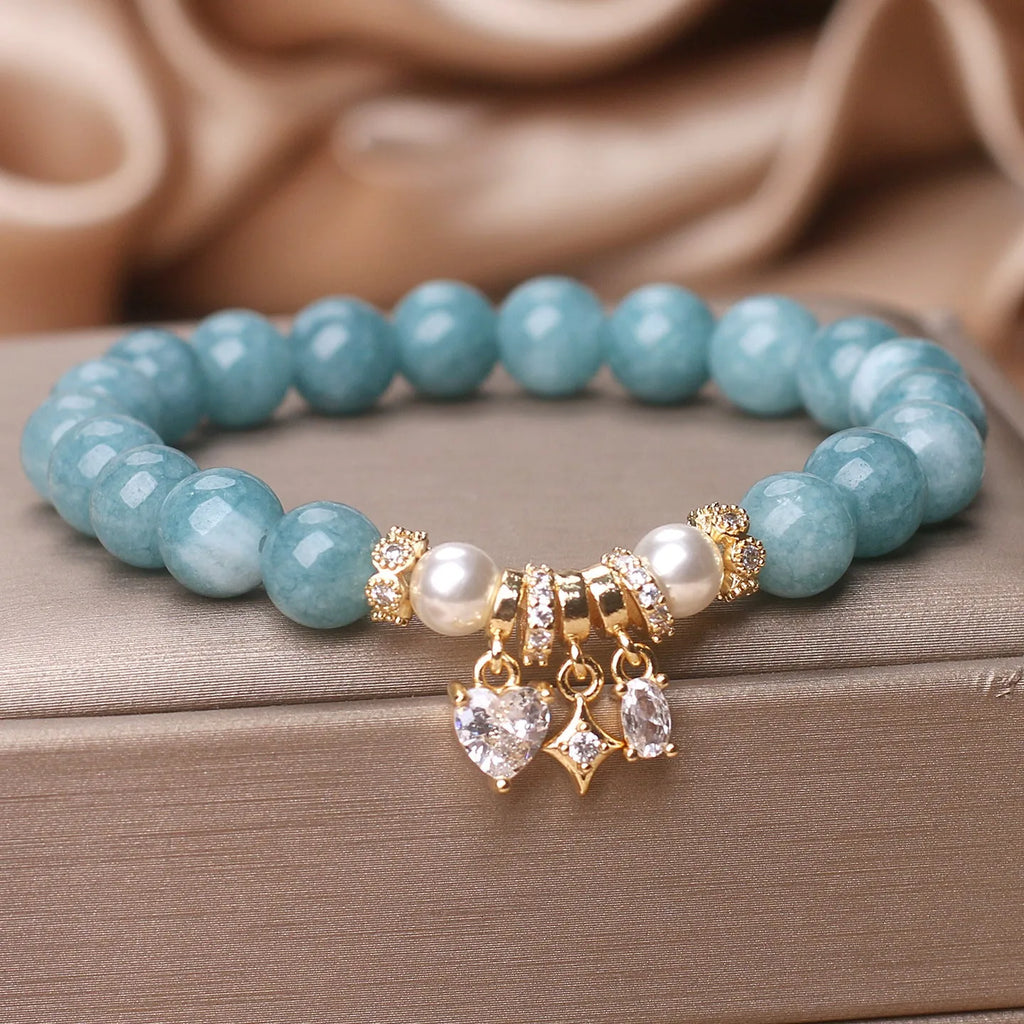 Blue water jade bracelet with heart-shaped zircon pendant and agate beads on display