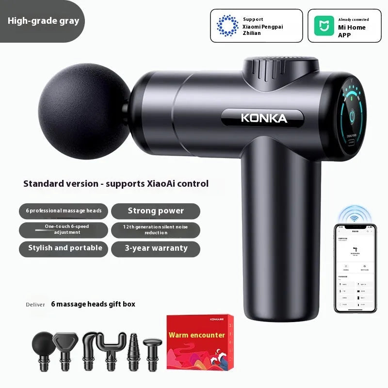 Konka professional electric mini massage gun in grey with multiple massage heads on a table