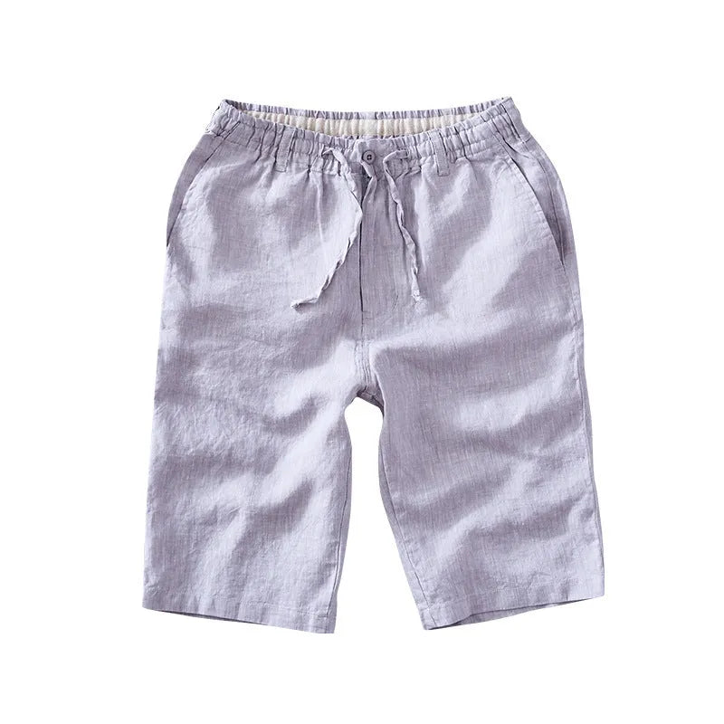 Men's loose-fitting linen capri trousers in a straight-leg style on a neutral background.