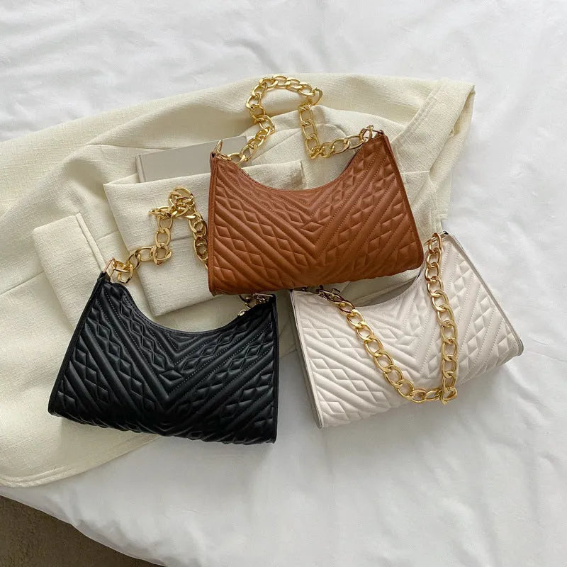 Brown PU pleated chain baguette shoulder bag showing vertical square shape and soft carry handle.