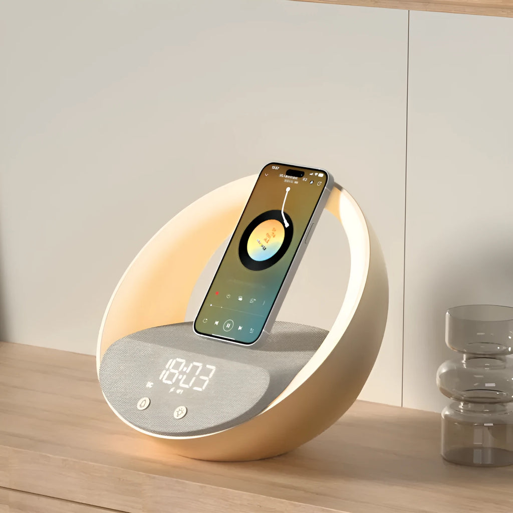 Beige multifunctional wireless charging clock with Bluetooth speaker and warm white LED wake-up light on a wooden table.