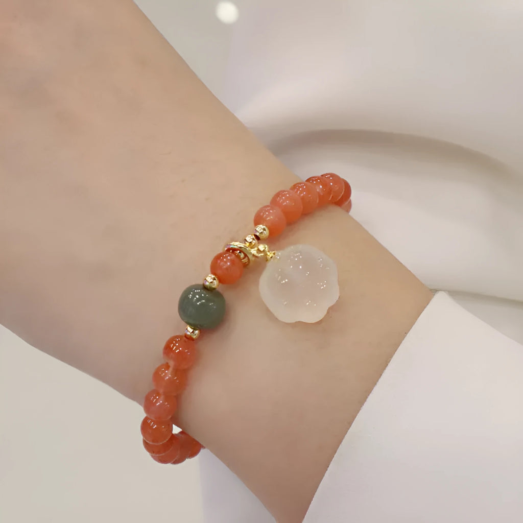 Natural red agate bracelet with jade inlay and a cat paw charm on a 6mm band.