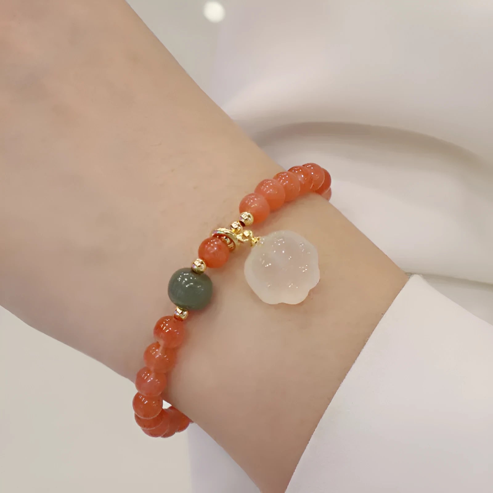 Natural red agate bracelet with jade inlay and a cat paw charm on a 6mm band.