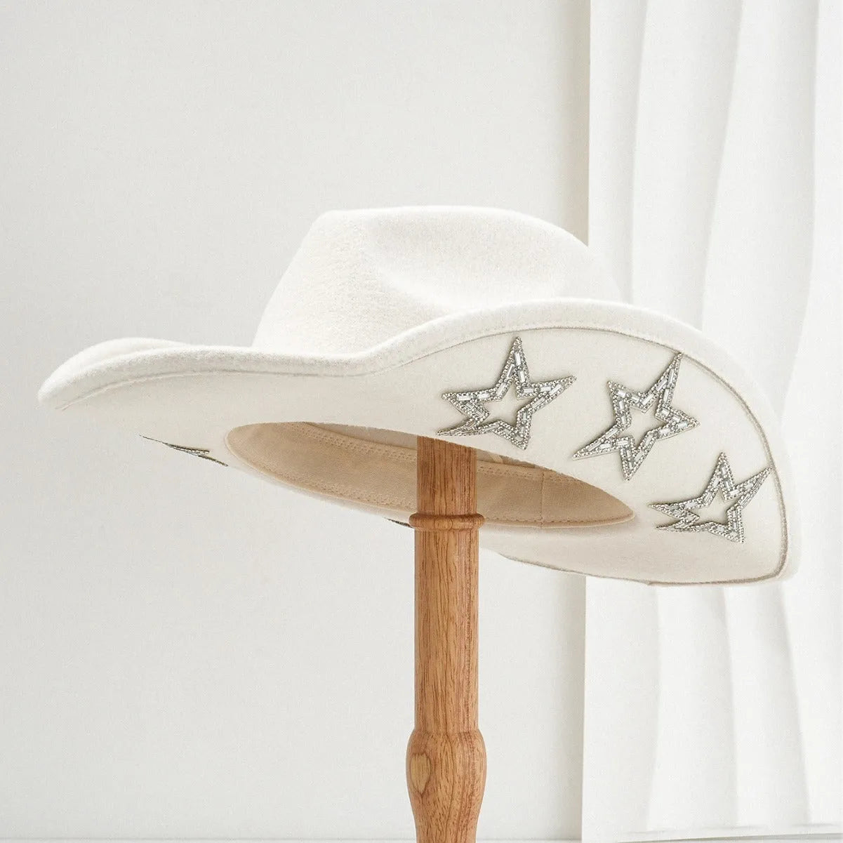 Beige polyester Western-style top hat with a conical crown and a silver hexagonal star decoration on the front.