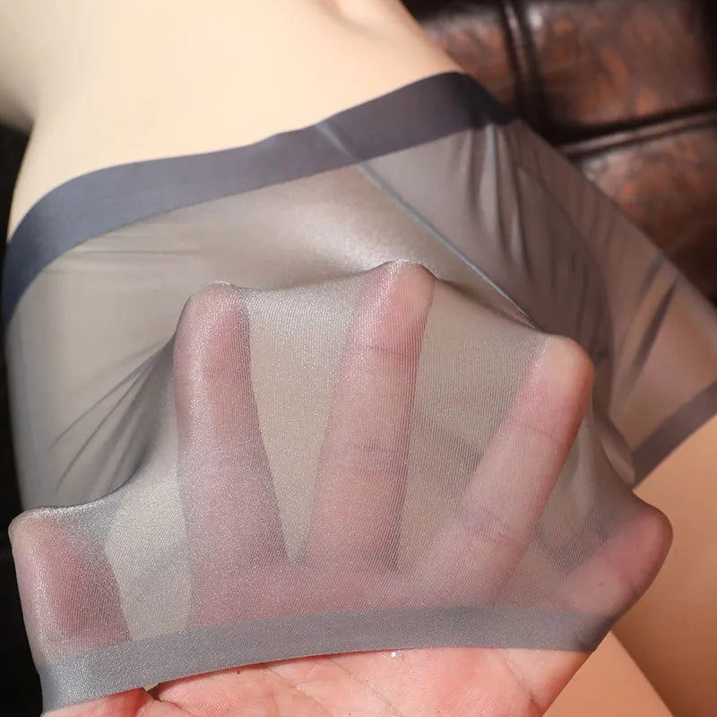 Men's ultra-thin transparent ice silk boxer shorts in light grey, shown flat.