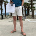 Man wearing solid colour straight-leg casual shorts in a loose fit.