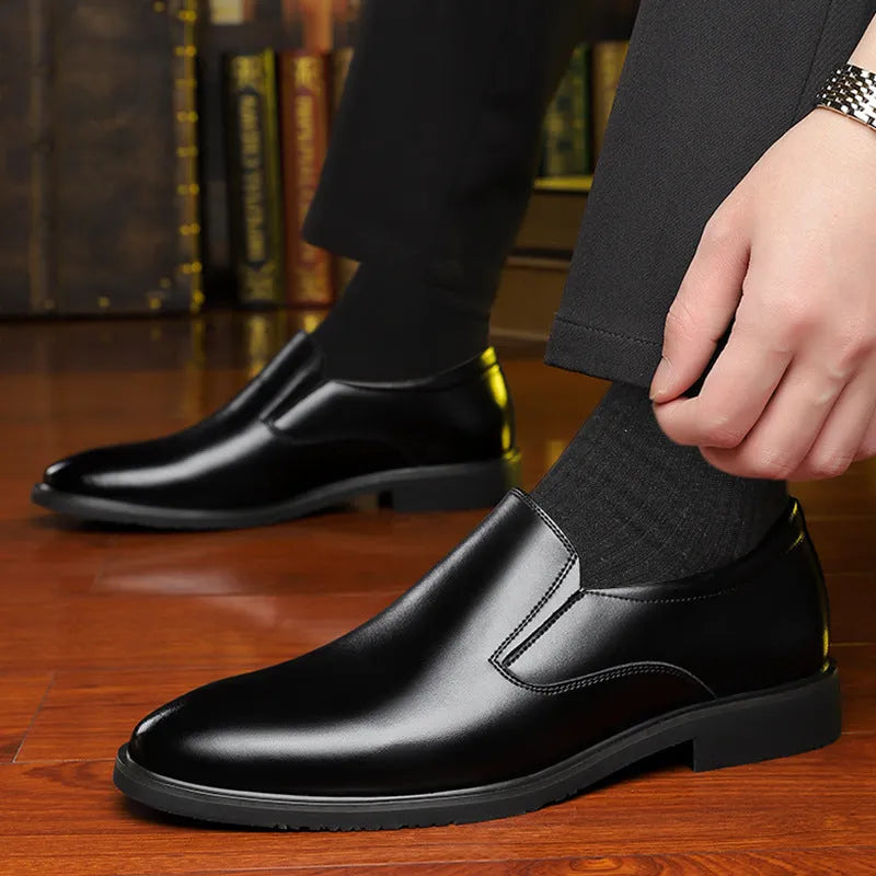 Men's black leather slip-on loafers with a rubber sole and leather toe cap on a white background.
