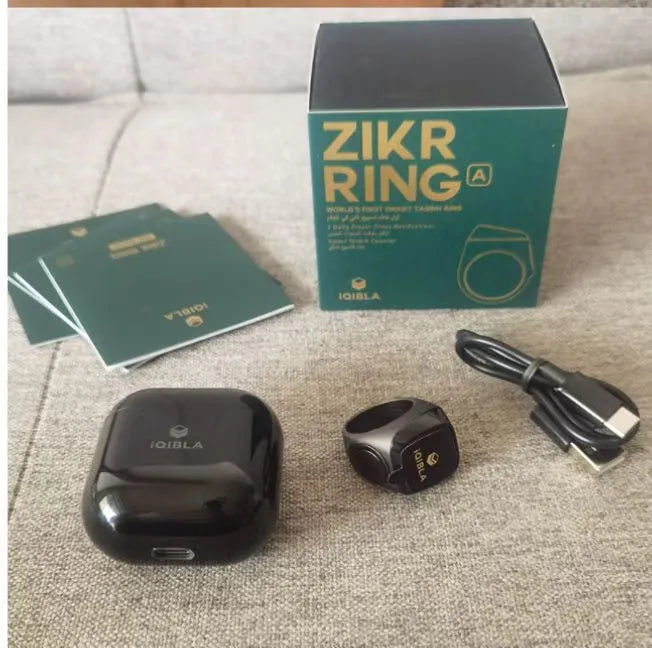 Zikr1 smart ring in silver on a finger, showing the OLED display and single CNC button.