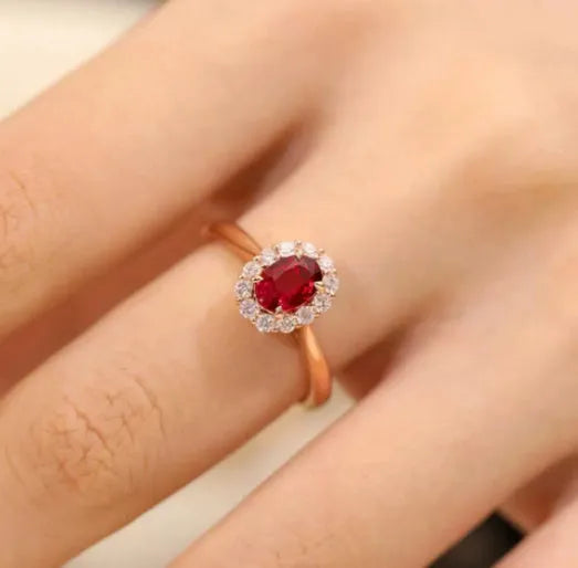 Gold Pigeon silver-plated ring with red blood gemstone and flower pattern, side view on white background