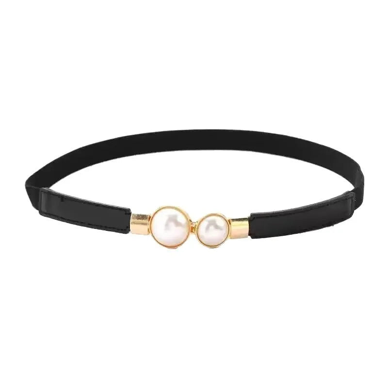 Thin black women's PU leather belt with alloy buckle fastening on jeans