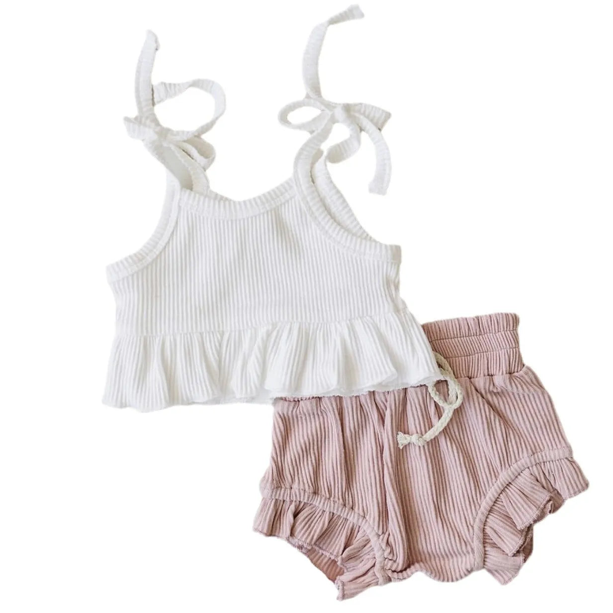 Baby girls white knitted cotton vest and pink shorts set on a light background