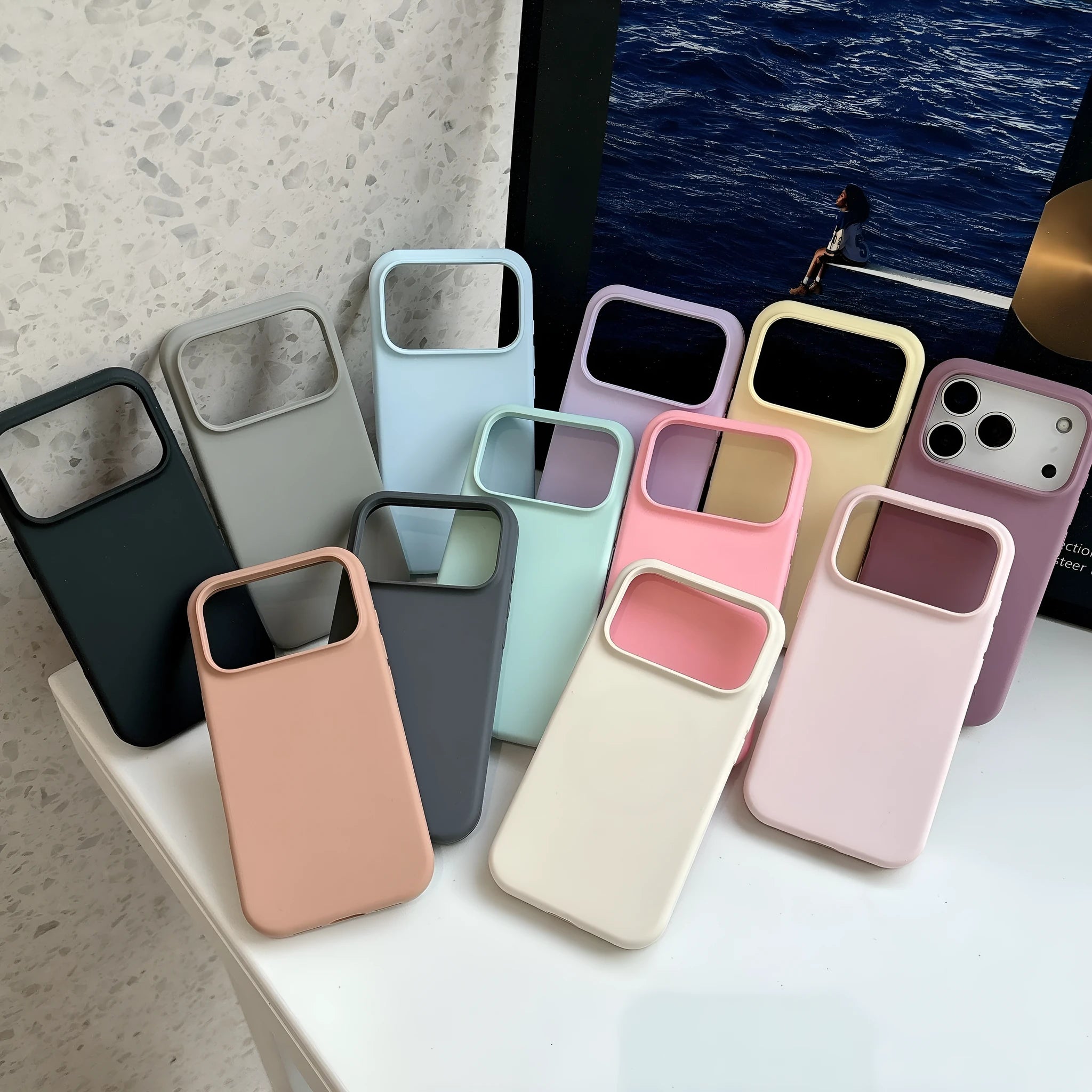 Liquid silicone magnetic iPhone case with Ai button in antique white colour on a table.