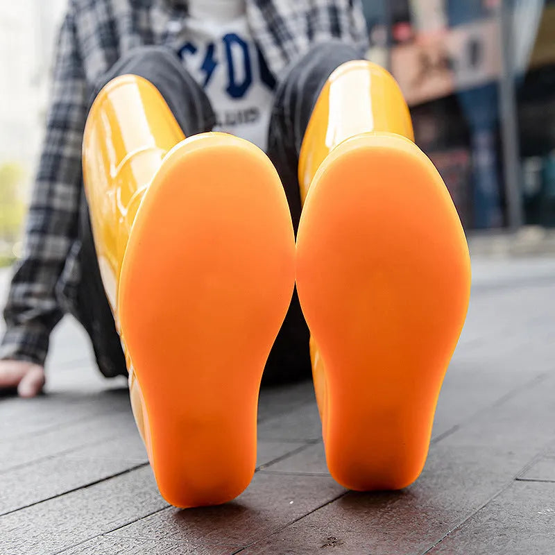White and yellow plastic washable rain boots with high-tube design and flat heels for labour protection