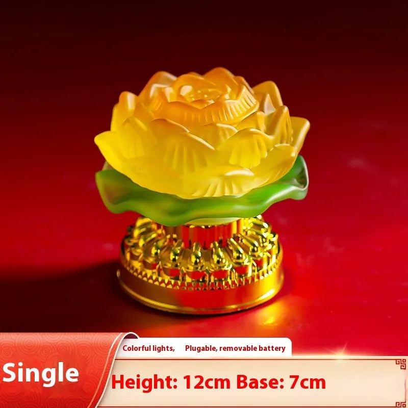 Yellow Chinese style Buddha lotus lamp on a wooden surface, shown in both flower bud and flowering designs.
