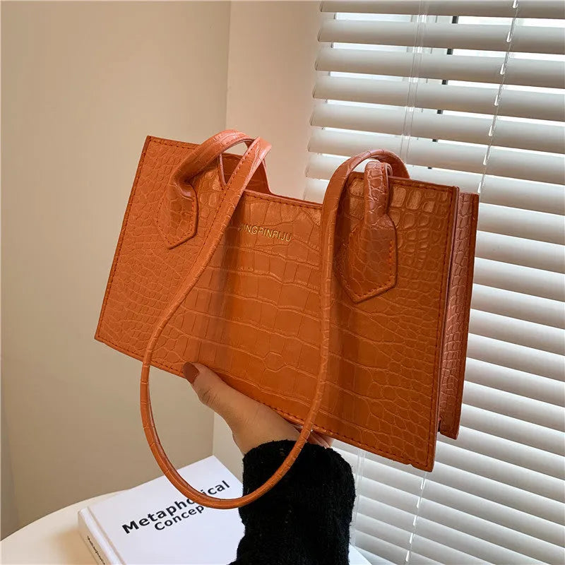 Small square PU handbag with crocodile pattern, sewing line detail, medium hard build, 27x16x7cm, black colour