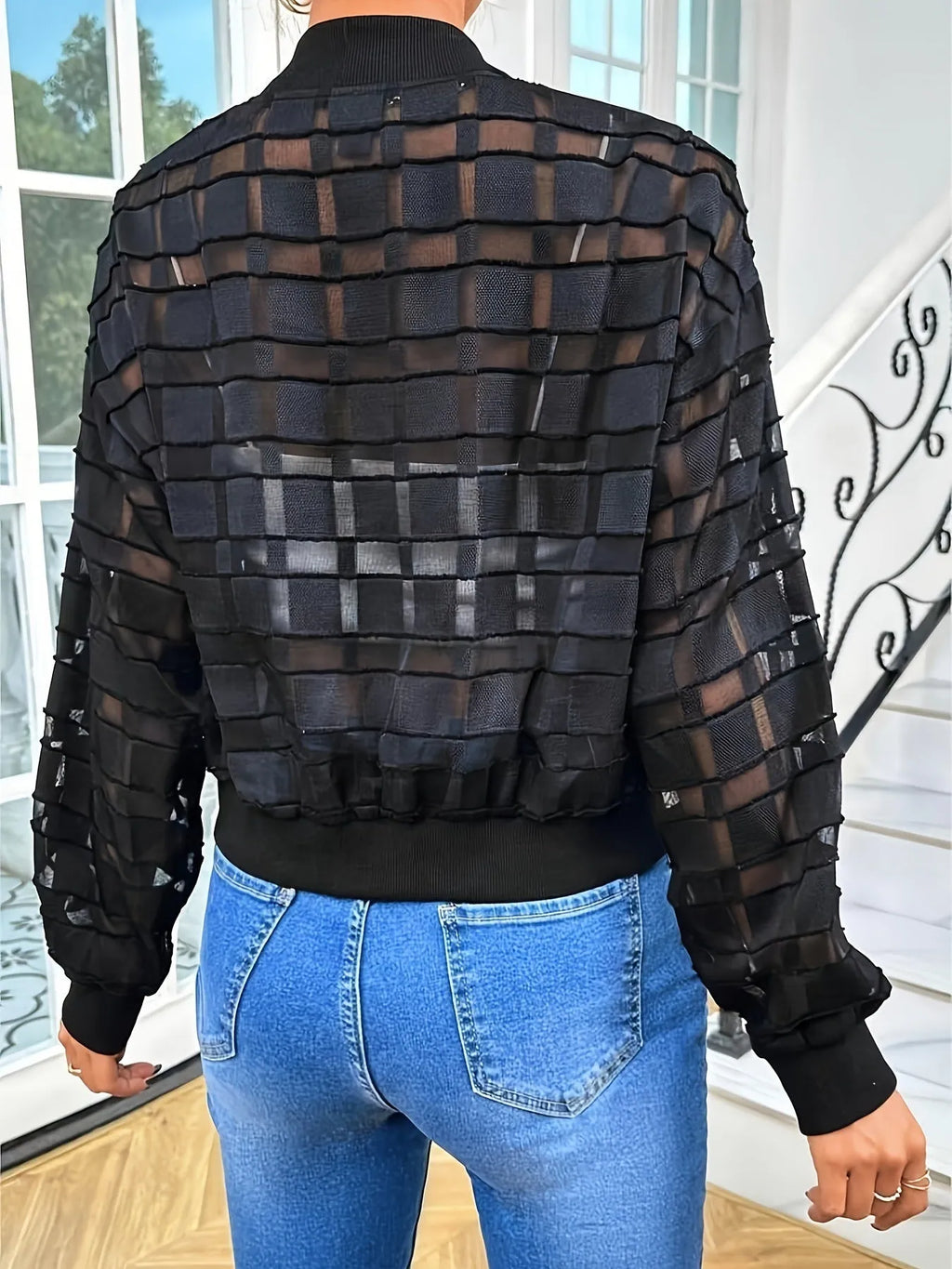 Black women's semi-transparent casual jacket with geometric pattern and front zipper.