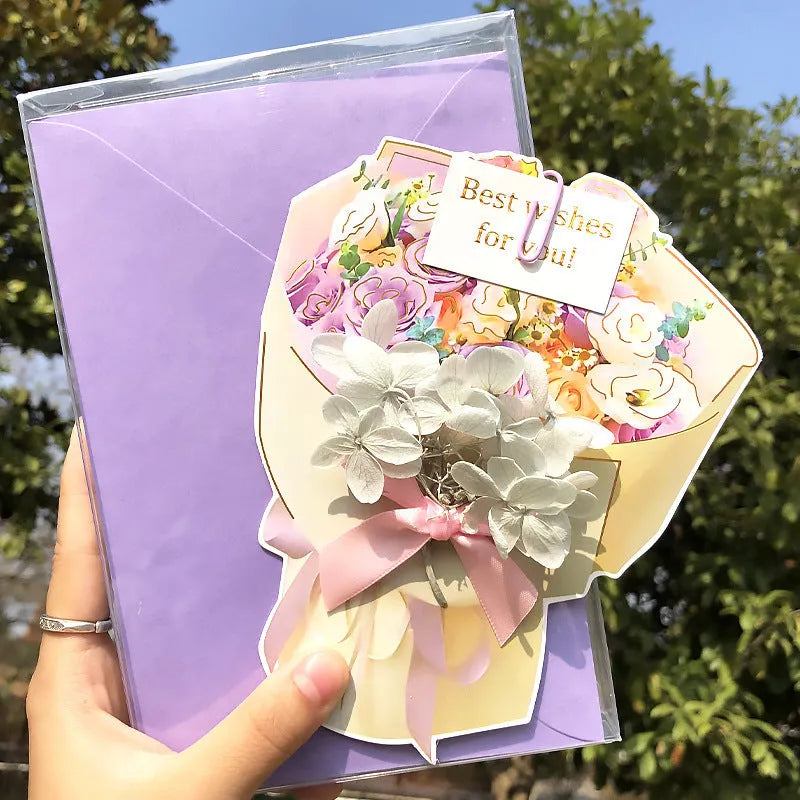 Handmade 3D butterfly-shaped greeting card with artificial flowers in a box, alongside its matching envelope.