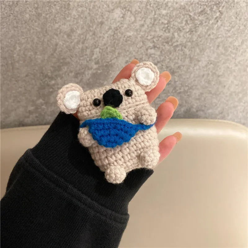Hand knitted AirPods protective sleeve with koala bear backpack design on Apple AirPods case