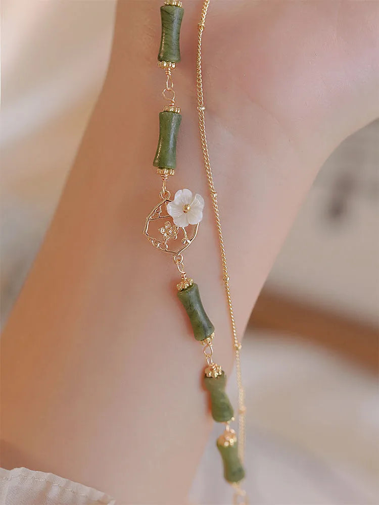 Natural olivine bracelet with Chinese double layer design featuring twin Bells of Ireland elements