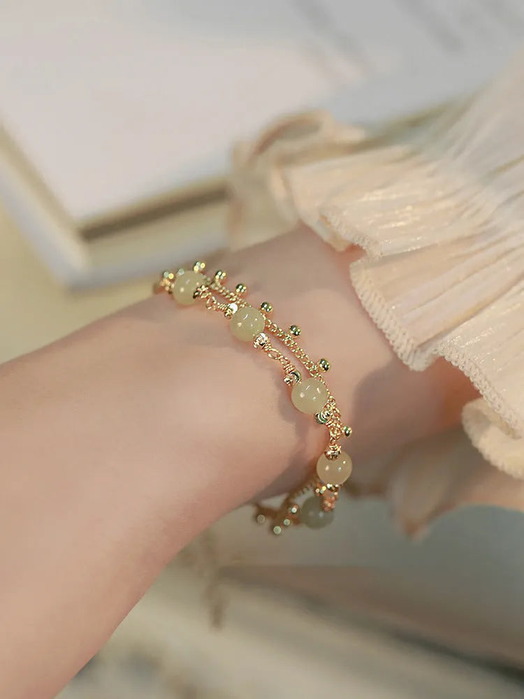 Hetian Jade bracelet with princess running beaded style on neutral background