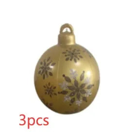 Large red and white striped inflatable Christmas ball ornament hanging on an outdoor tree