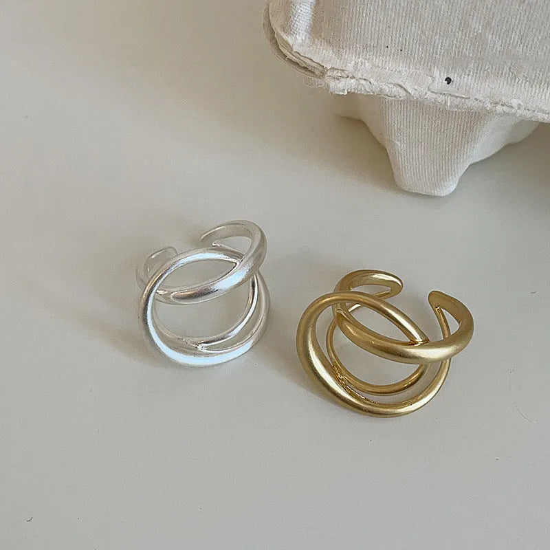 Women's geometric open ring with interlaced design in matte gold or silver tone metal