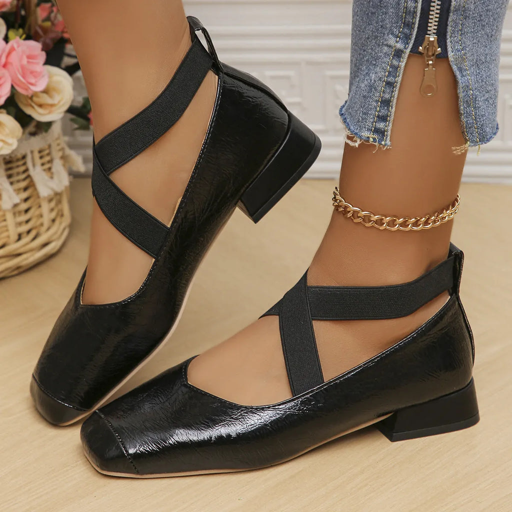 Gold slip-on square toe evening pumps with a low heel on a white background.