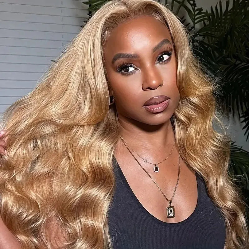 Light brown long synthetic curly wig with big waves and side bangs shown at medium length