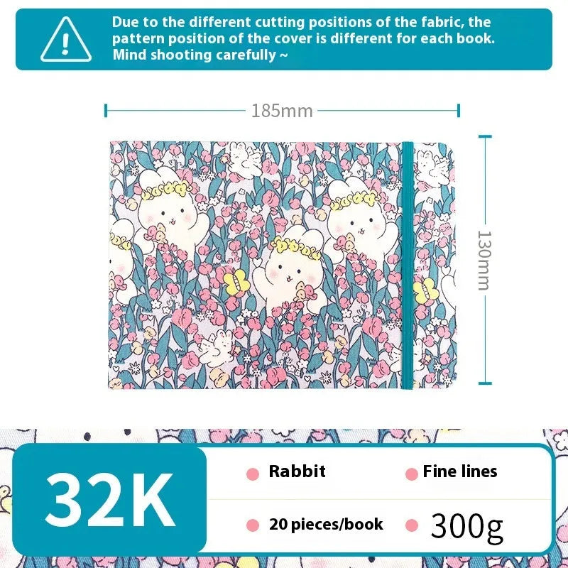 Feiluniao handmade fabric watercolour notebook with illustrated cover, open to show blank paper pages.
