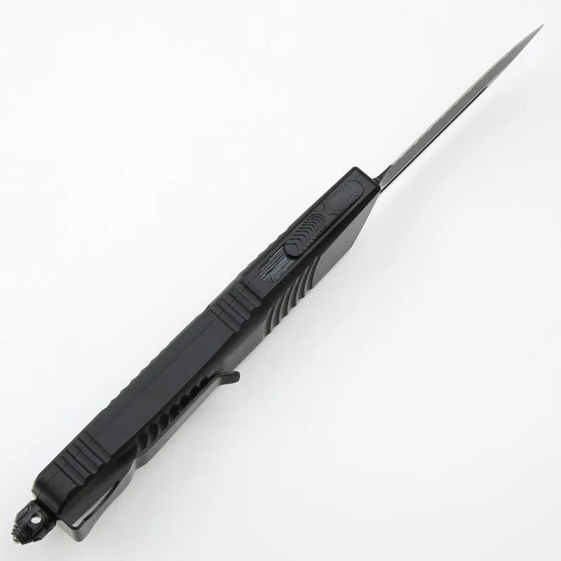 Black folding knife with D2 steel blade and aviation aluminium handle open on a dark surface