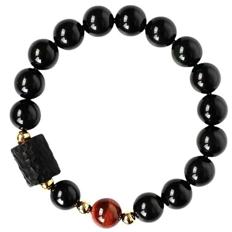 Obsidian bracelet with 10mm yellow tiger eye beads showing manual processing details and retro circle style