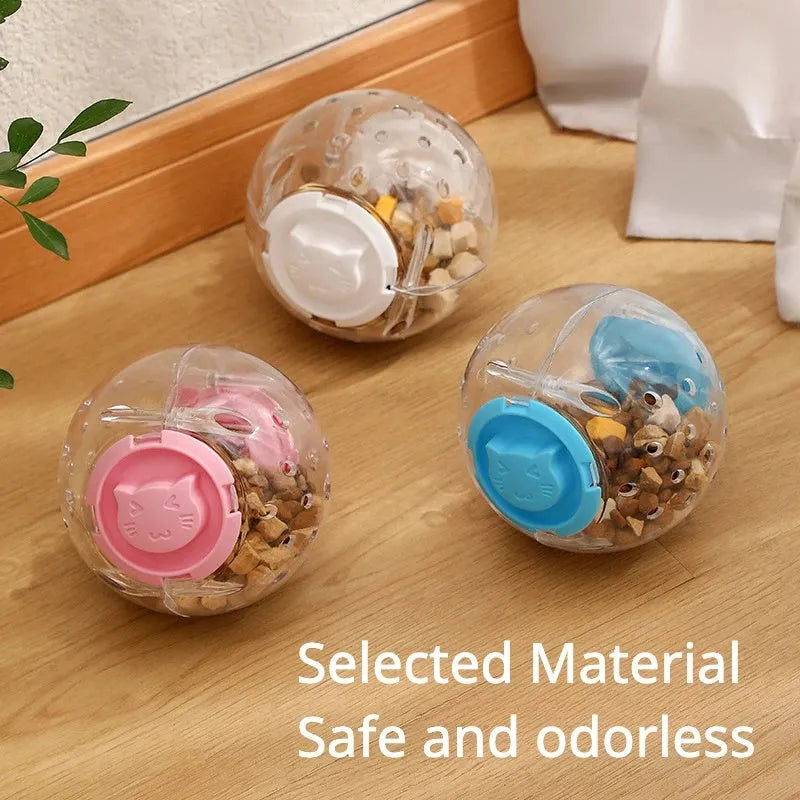 Clear blue ABS plastic slow feeder ball for cats, 11.5cm in diameter, on a wooden floor.