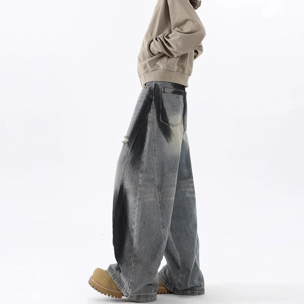 Men's blue ripped jeans with splash-ink wash pattern and loose fit silhouette