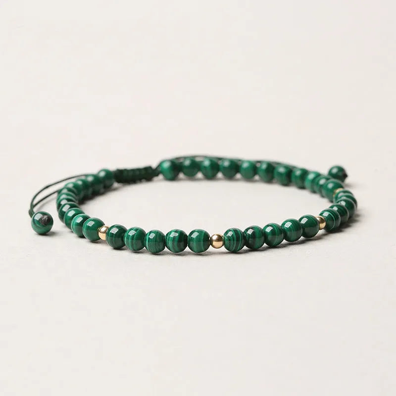 Green malachite stone bracelet with golden beads on woven strap, zodiac animal motif.