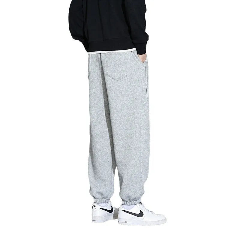 Men's loose fit sports trousers in grey colour with elastic waistband and drawstring closure