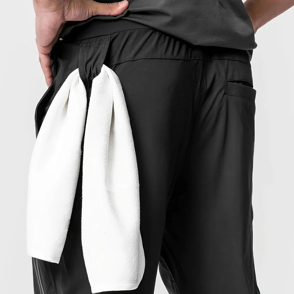 Men's solid colour polyester jogger pants in black, mid-waist style, casual sports trousers