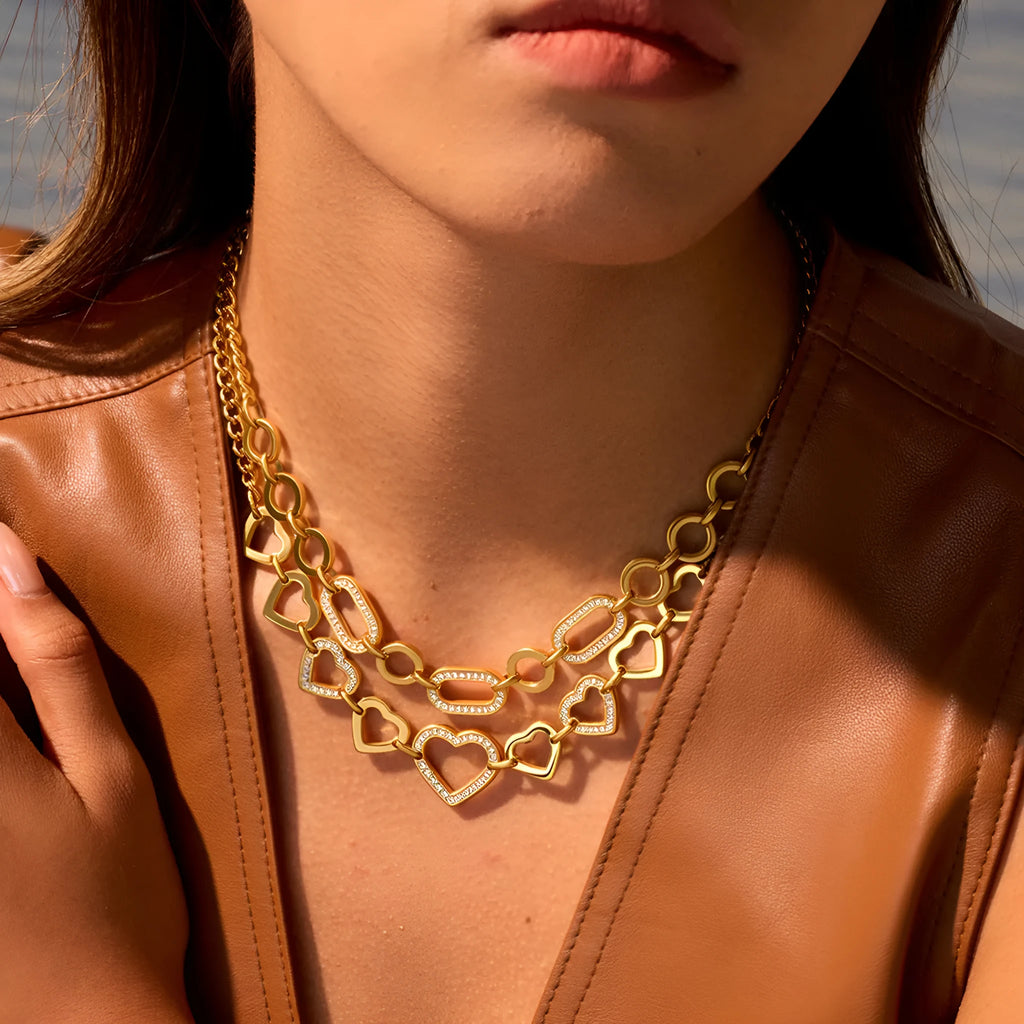 Geometric heart-shaped stainless steel pendant necklace with 18K gold finish on clavicle-length regular chain