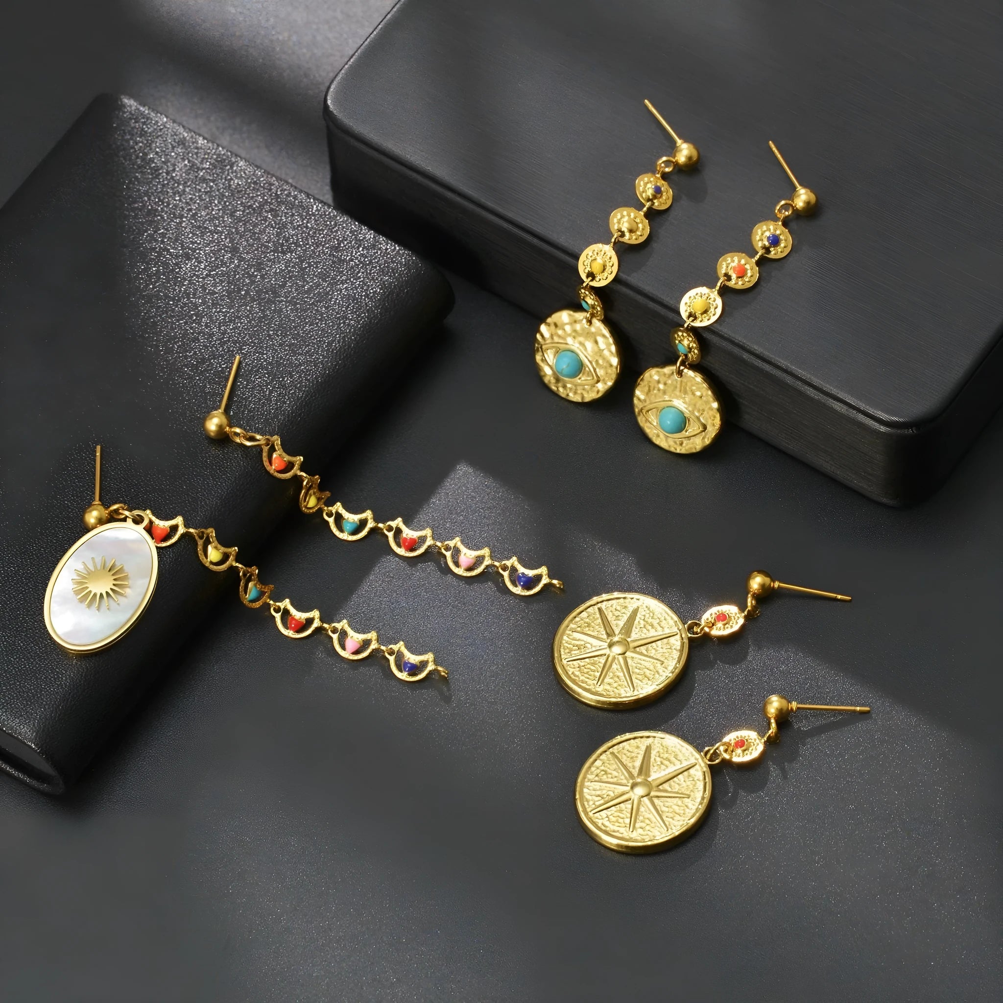 Stainless steel geometric earrings showing star, eye and shell sun design variations