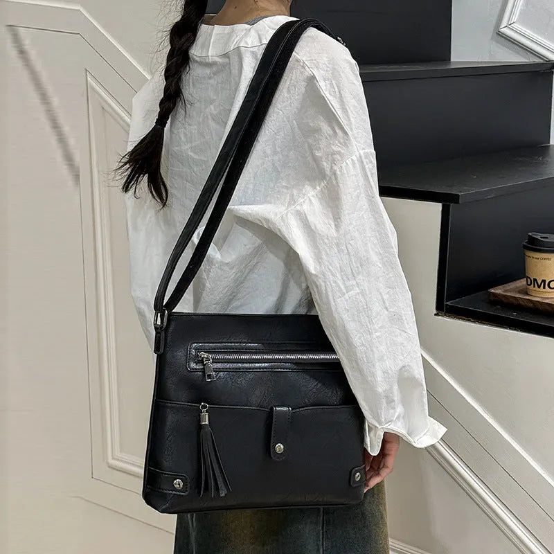 Women's soft PU tassel crossbody handbag in horizontal square shape with zipper compartments, available in beige, black, brown, coffee