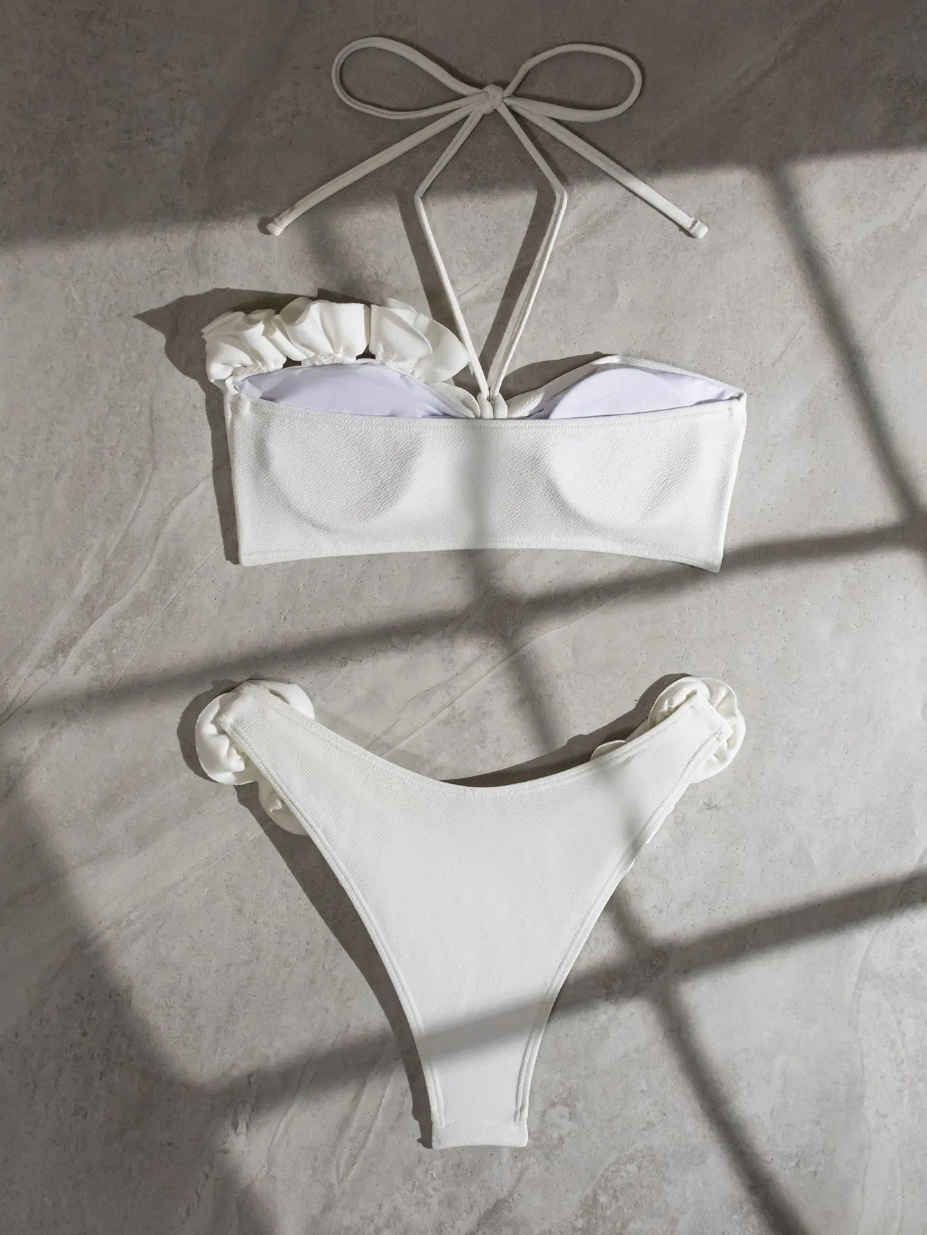 White halter swimsuit with three-dimensional floral lace-up front and split sides