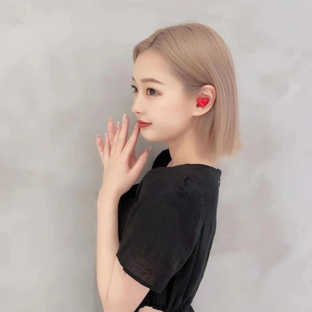 Heart-shaped wireless Bluetooth headphones in red and pink colour options with charging cable