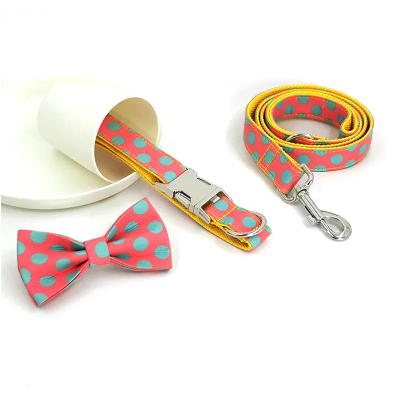 Yellow polka dot dog collar with bow and matching lead rope set on a white background.