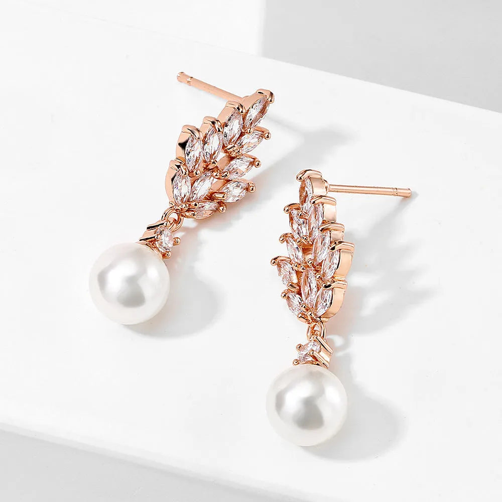 Gold, platinum, and rose gold plated geometric flower earrings with micro-inlaid zircon and pearl details.