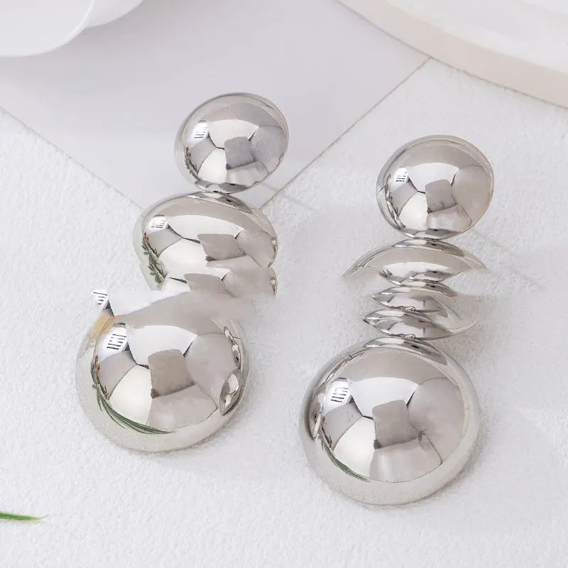 Retro women's polka dot metal bead drop earrings in frosted gold finish on a neutral background