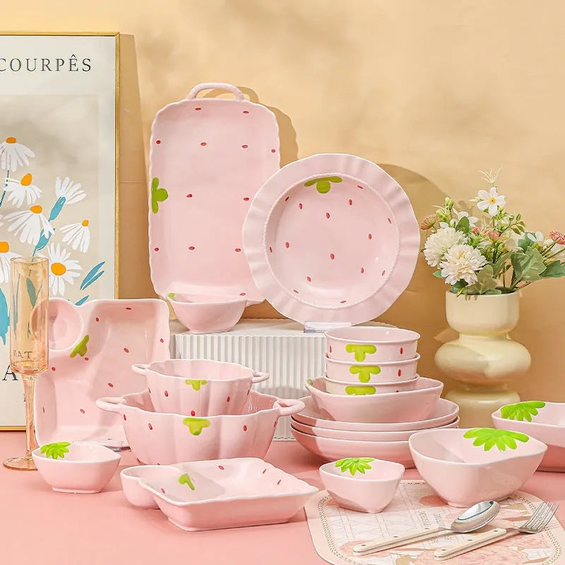 Cute porcelain dinnerware set with strawberry design, instant noodle bowl, twist spoon, and flower-shaped plates on table.